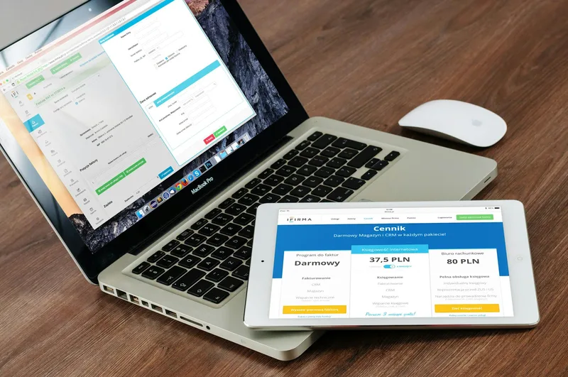 Developer setting up payment gateway plugin integration on a tablet and laptop