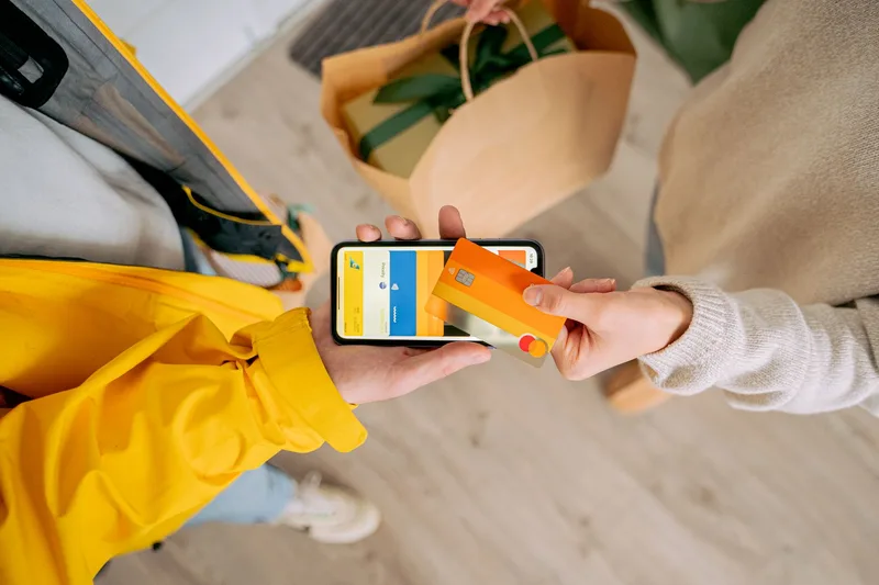 Person making a contactless mobile payment with a smartphone for an online order