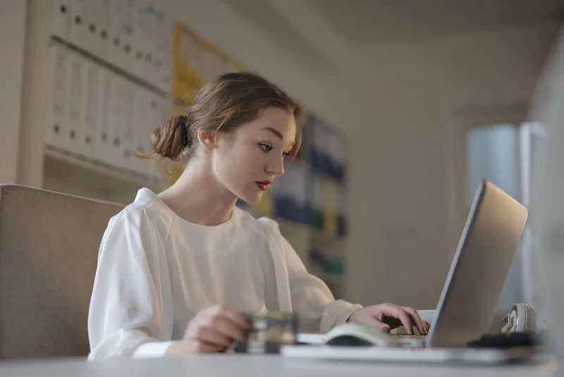 Business owner setting up a new account on a laptop for an online payment platform
