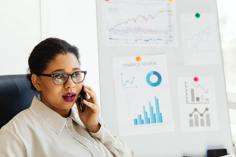 Businesswoman reviewing financial charts and payment data for her ecommerce store
