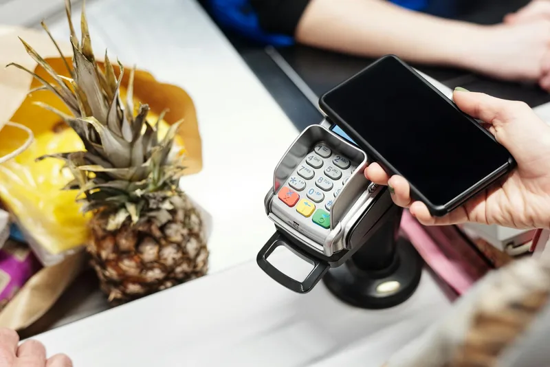 Mobile phone displaying checkout payment screen with card and Apple Pay options for UAE online store