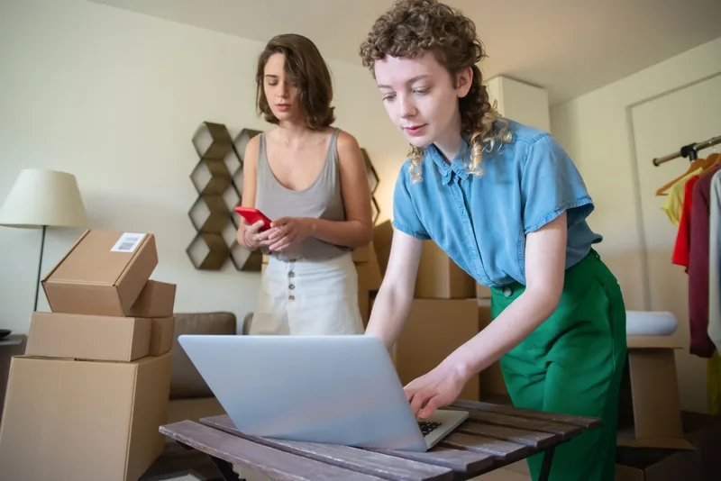 Women managing an ecommerce business with products and laptop, representing UAE online sellers reconciling marketplace orders