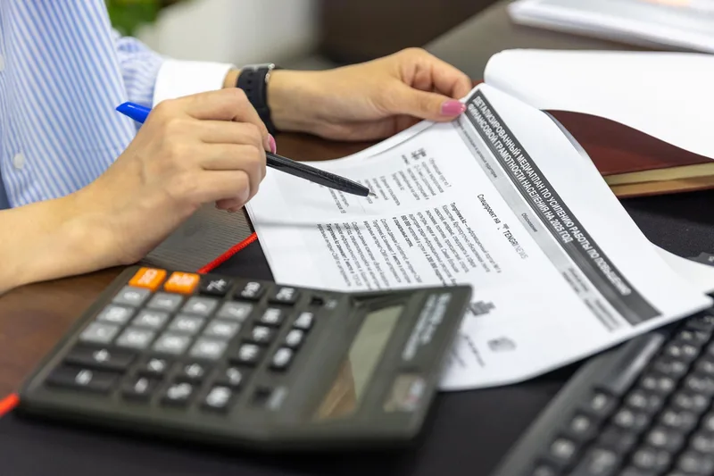 Businesswoman reviewing financial documents and pricing plans for accounting software in UAE office