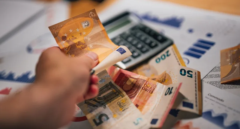 Business professional analyzing fee calculations and financial data